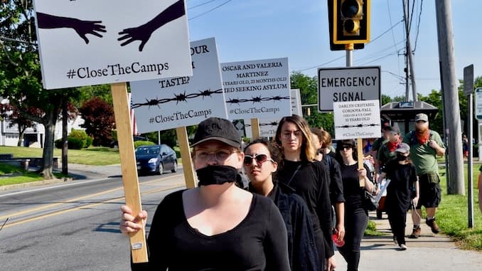A silent #ClosetheCamps vigil at the Bristol 4th of July Parade