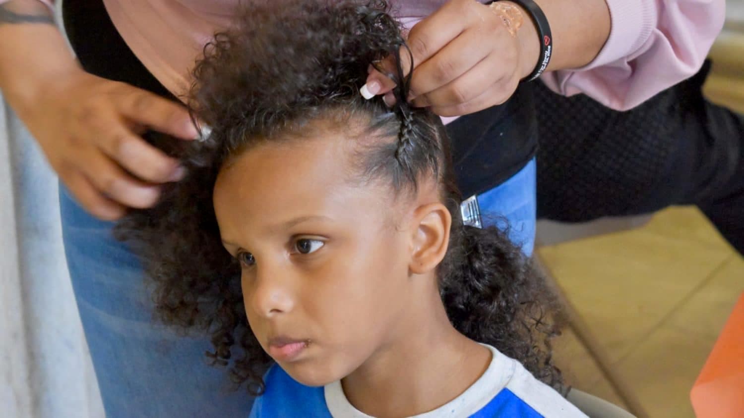 Natural hair braiders demonstrate their craft at the State House