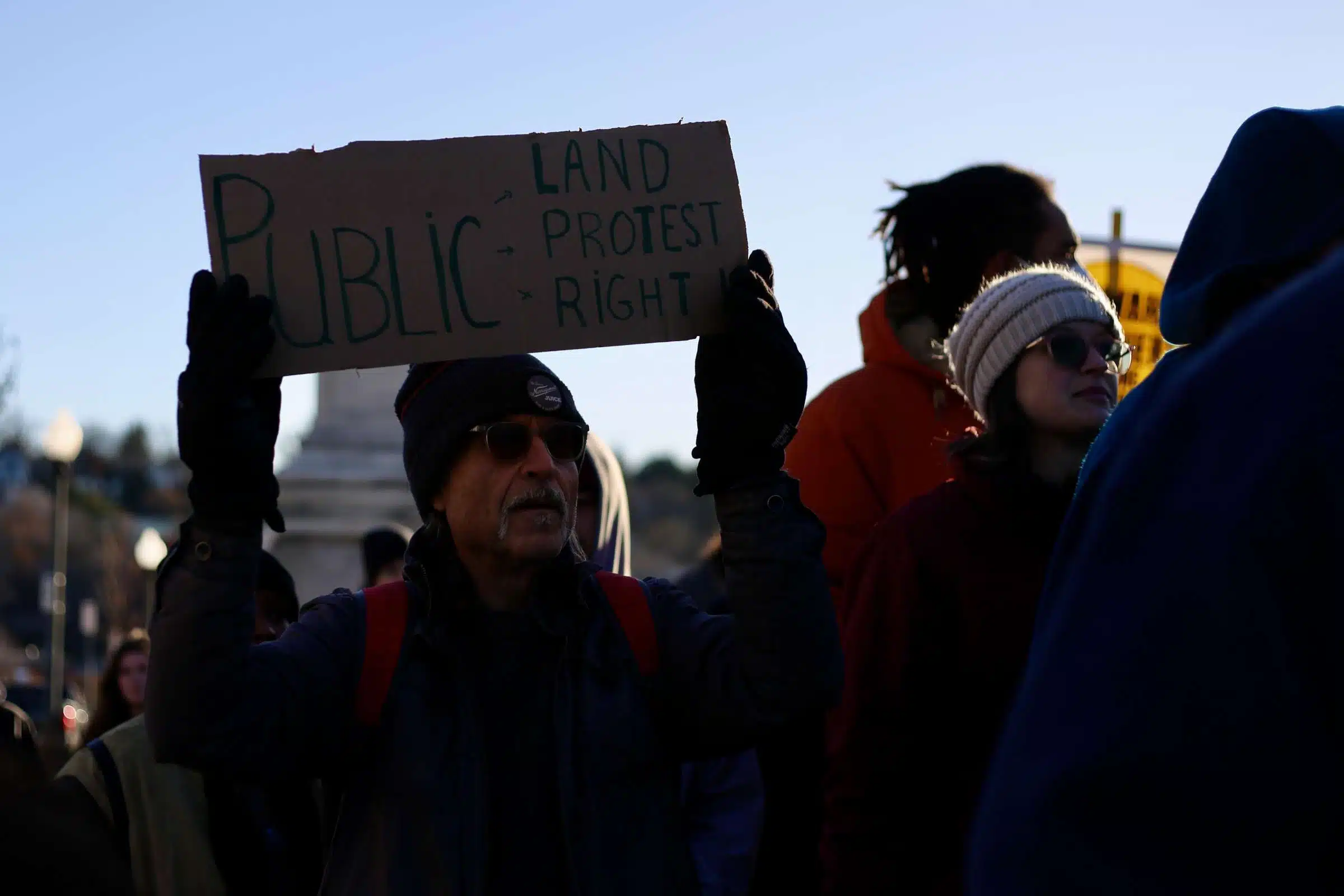 A protesters at a rally against Rhode Island Governor Daniel McKee, opposing his plan to evict a homeless encampment