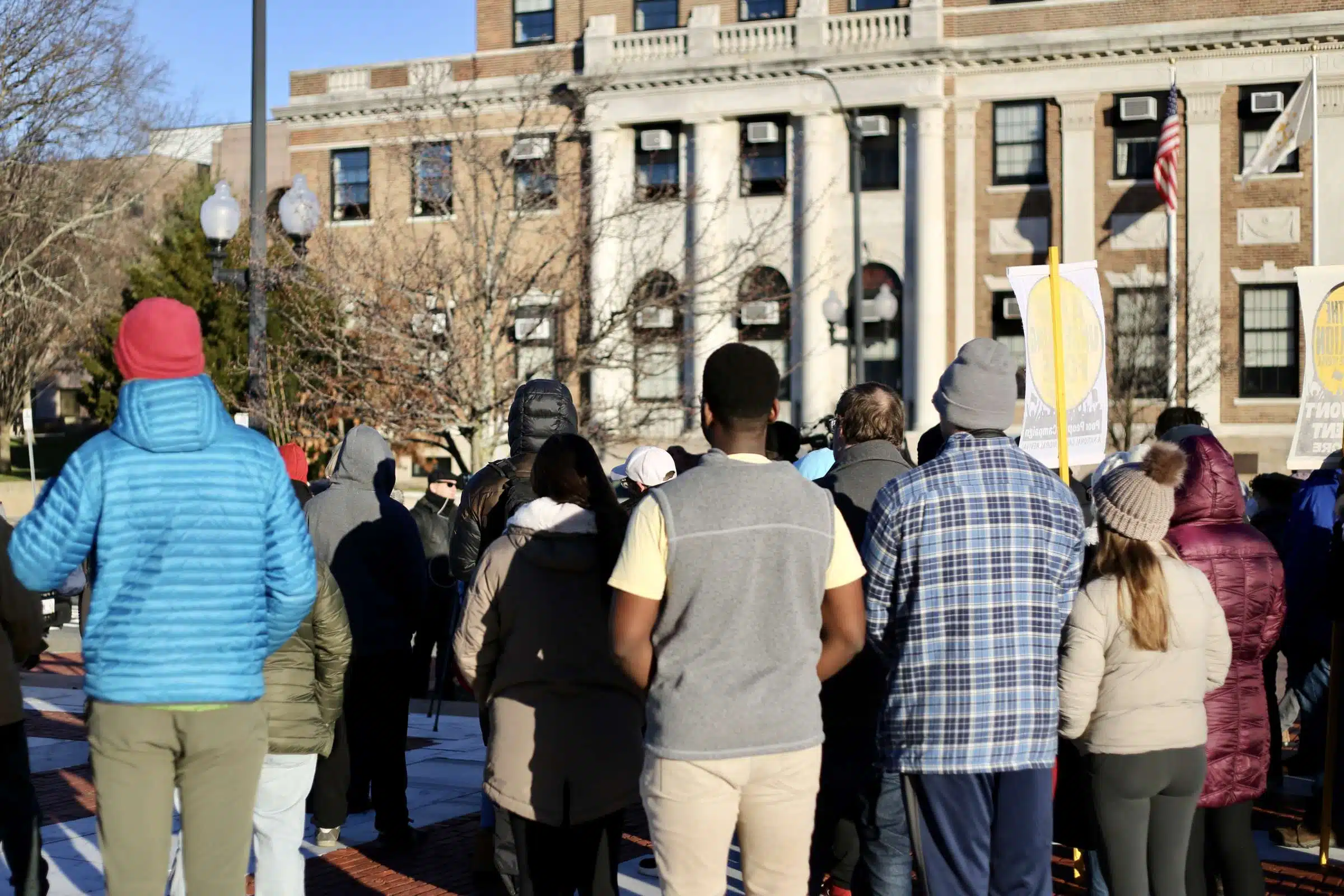 Protesters at a rally against Rhode Island Governor Daniel McKee, opposing his plan to evict a homeless encampment