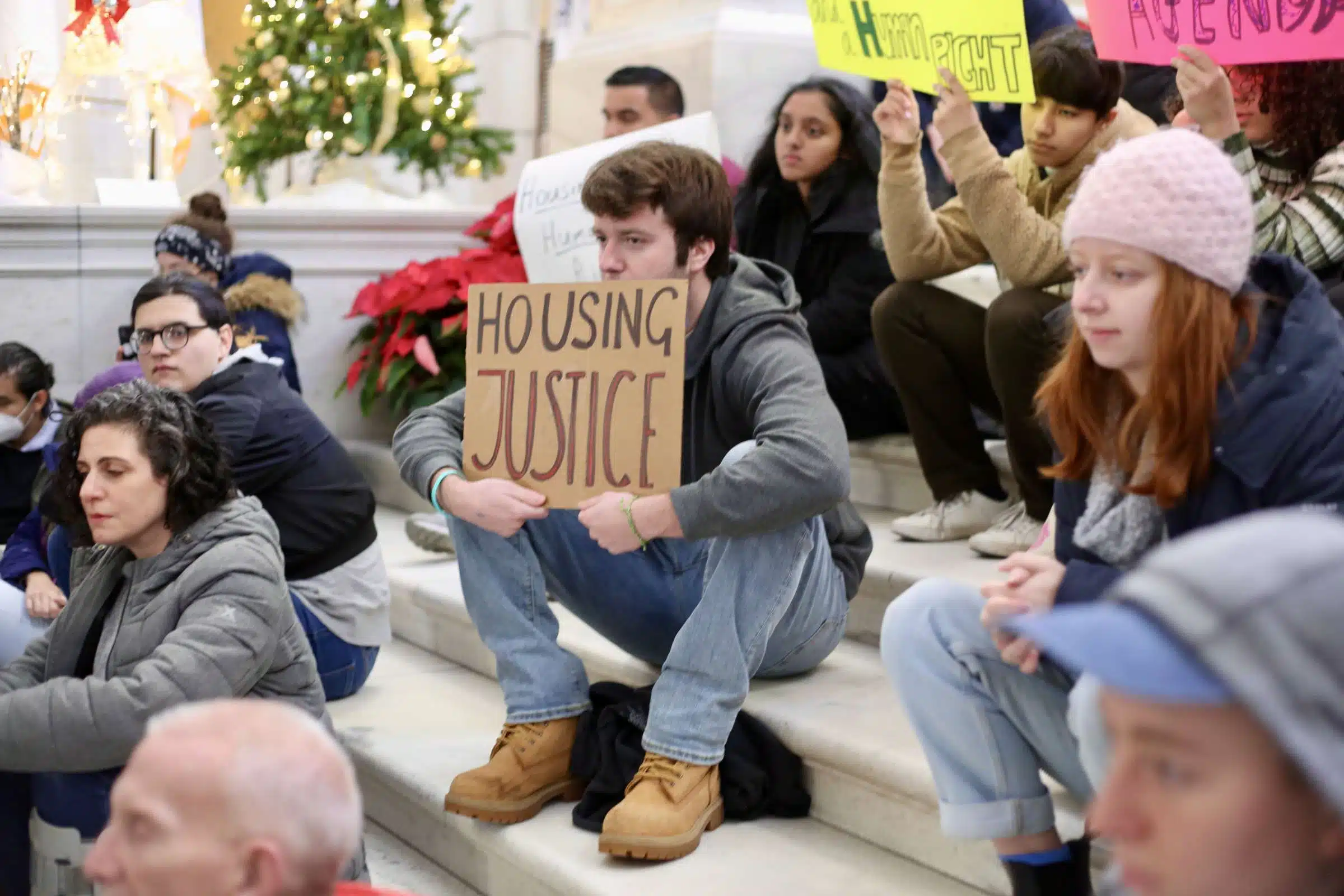 Protester at a rally against Rhode Island Governor Daniel McKee, opposing his plan to evict a homeless encampment