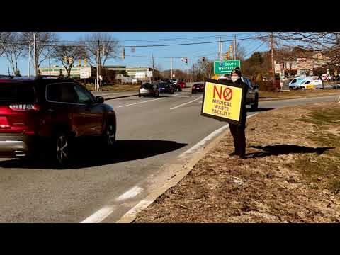Local Groups Hold Signs Near a Road to Rally Against Proposed Medical Waste Facility in West Warwick