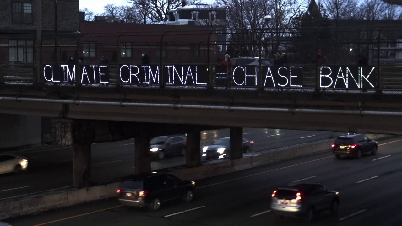 "CLIMATE CRIMINAL = CHASE BANK": Sign Displayed Over I-95 Near the Rhode Island State House