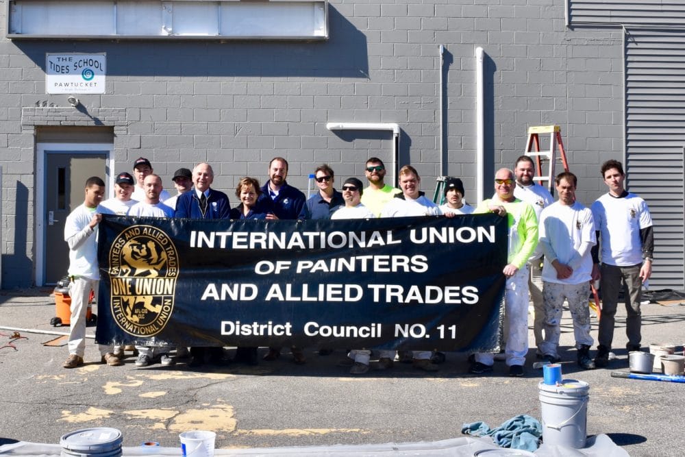Painters union volunteers give new Tides Family Services building a much needed upgrade