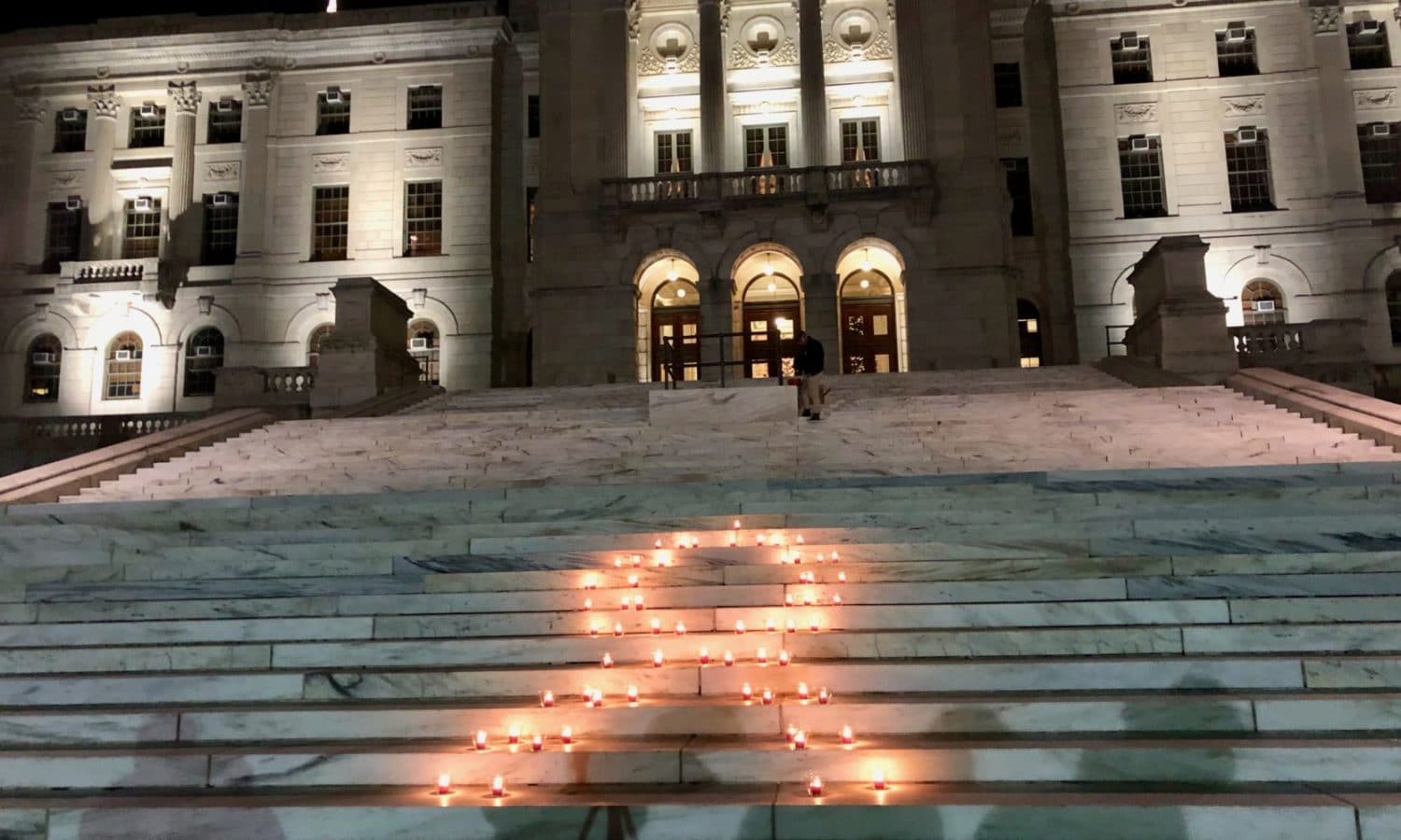A community gathering to commemorate World AIDS Day at the RI State House