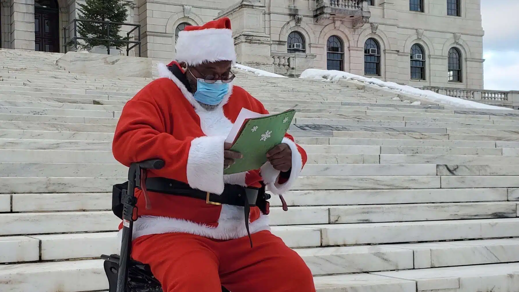 Santa Claus visits State House to advocate for the evicted and housing insecure
