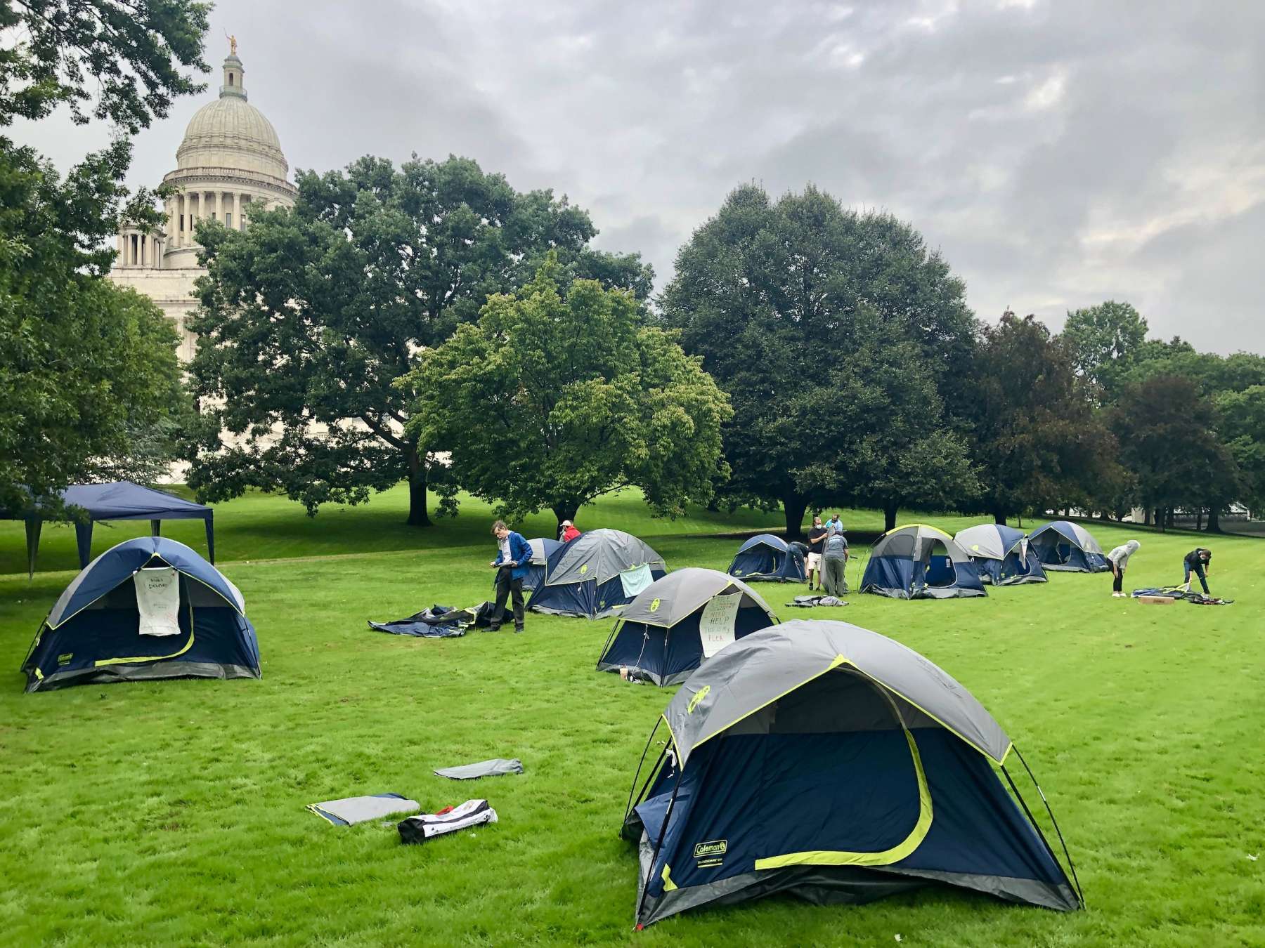 Homelessness advocates erect tents on the State House lawn to be noticed